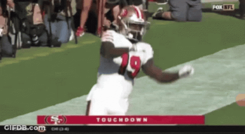 A Football Player With The Number 19 On His Jersey Is Running On The Field GIF