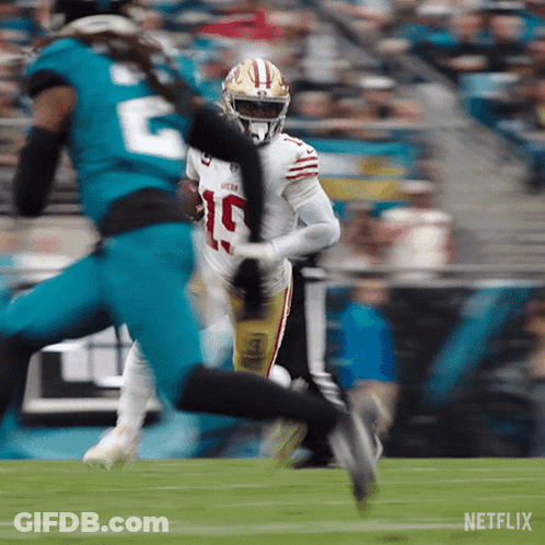 A Football Player With The Number 19 On His Jersey Is Running With The Ball GIF