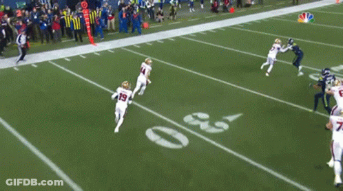A Football Player With The Number 19 On His Jersey Runs On The Field GIF
