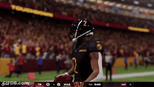 A Football Player With The Number 2 On His Helmet Stands On The Field GIF