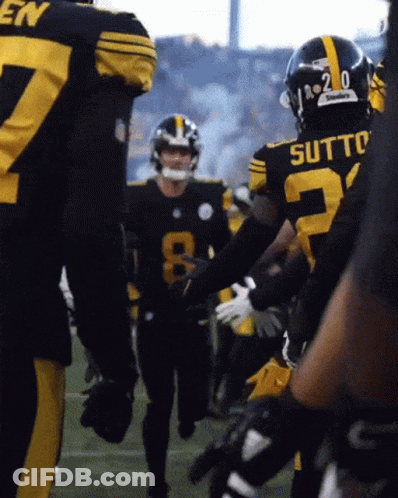 A Football Player With The Number 20 On His Helmet Is Talking To Another Player GIF