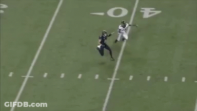 A Football Player With The Number 20 On His Jersey Is Catching A Ball GIF