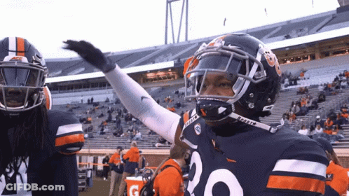 A Football Player With The Number 20 On His Jersey Stands In A Stadium GIF