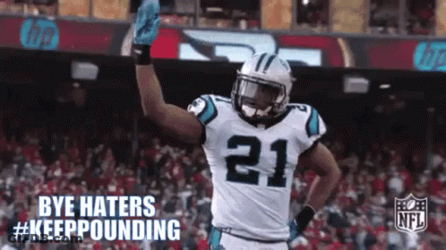 A Football Player With The Number 21 On His Jersey Is Waving His Hand . GIF