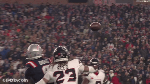 A Football Player With The Number 22 On His Jersey Catches The Ball GIF