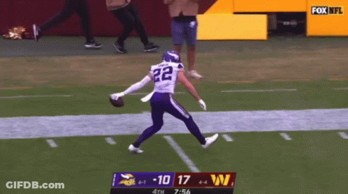 A Football Player With The Number 22 On His Jersey Is Running On The Field GIF
