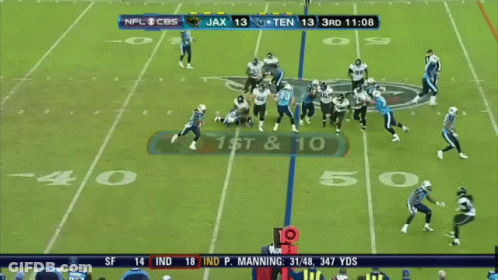 A Football Player With The Number 22 On His Jersey Is Running With The Ball GIF