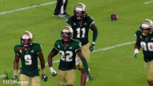 A Football Player With The Number 22 On His Jersey Is Surrounded By Other Players GIF