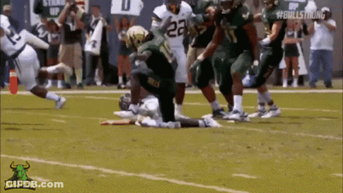 A Football Player With The Number 23 On His Jersey Is Kneeling On The Field GIF