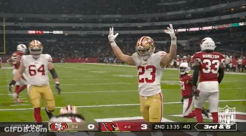 A Football Player With The Number 23 On His Jersey Stands On The Field GIF