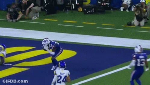 A Football Player With The Number 24 On His Jersey Catches A Pass GIF