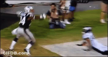 A Football Player With The Number 24 On His Jersey Is Running Towards Another Player GIF