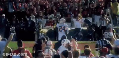 A Football Player With The Number 24 On His Jersey Is Surrounded By Fans GIF