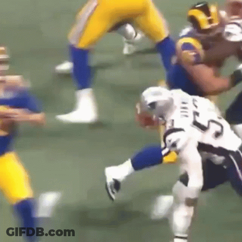 A Football Player With The Number 25 On His Jersey Is Being Tackled By Another Player GIF