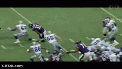 A Football Player With The Number 26 On His Jersey Is Running With The Ball GIF