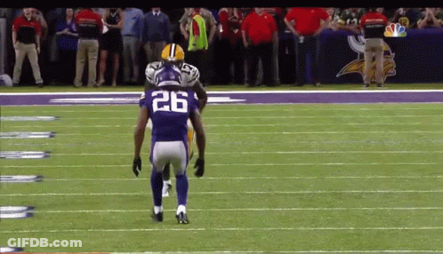 A Football Player With The Number 26 On His Jersey Stands On The Field GIF