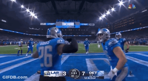 A Football Player With The Number 26 On His Jersey Stands On The Field GIF