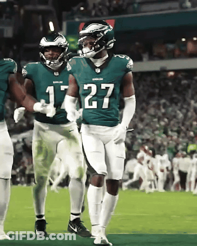 A Football Player With The Number 27 On His Jersey Stands On The Field GIF