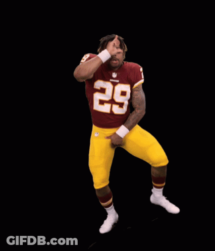 A Football Player With The Number 28 On His Jersey Is Dancing GIF
