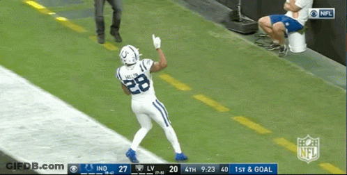 A Football Player With The Number 28 On His Jersey Stands On The Field GIF