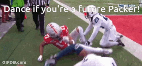 A Football Player With The Number 29 On His Jersey Is Being Tackled By Another Player GIF