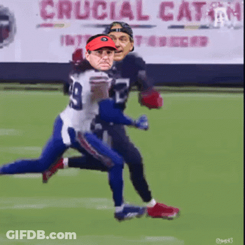 A Football Player With The Number 29 On His Jersey Is Being Tackled GIF