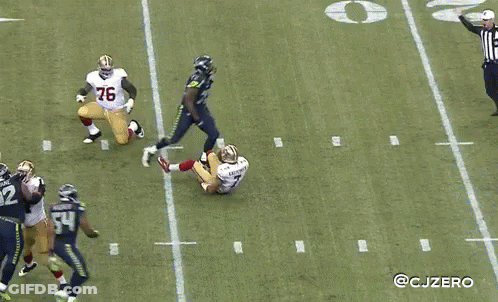 A Football Player With The Number 29 On His Jersey Stands On The Field GIF