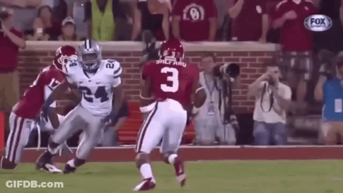 A Football Player With The Number 3 On His Jersey Is Running On The Field . GIF