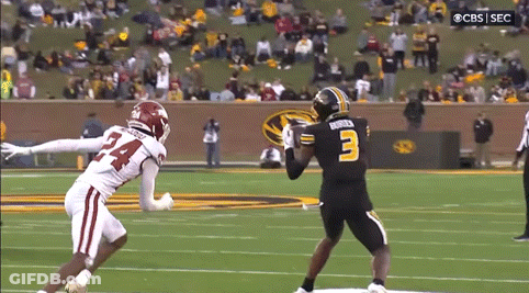A Football Player With The Number 3 On His Jersey Is Trying To Catch A Pass From Another Player GIF