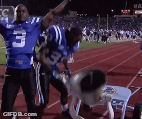 A Football Player With The Number 3 On His Jersey Stands On A Track GIF