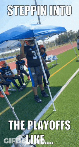 A Football Player With The Number 3 On His Jersey Stands Under A Blue Tent GIF