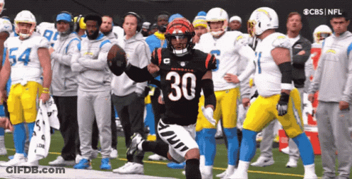 A Football Player With The Number 30 On His Jersey Is Running On The Field GIF