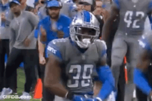 A Football Player With The Number 30 On His Jersey Is Standing On The Field . GIF