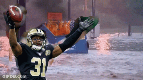A Football Player With The Number 31 On His Jersey Is Holding A Football GIF