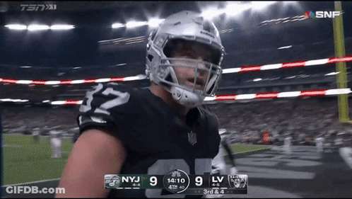 A Football Player With The Number 32 On His Jersey Stands On The Field GIF