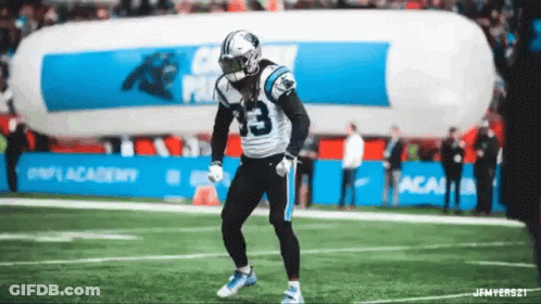 A Football Player With The Number 33 On His Jersey Is Dancing On The Field GIF