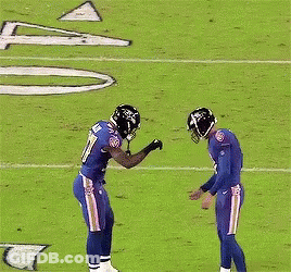 A Football Player With The Number 37 On His Jersey Stands On The Field GIF