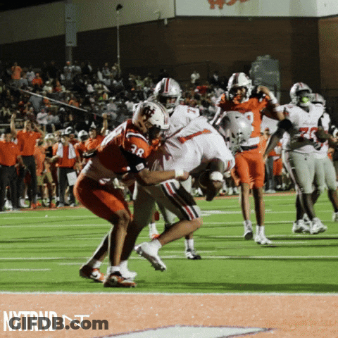 A Football Player With The Number 38 On His Jersey Is Being Tackled By Another Player On The Field GIF