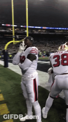 A Football Player With The Number 38 On His Jersey Stands On The Field GIF