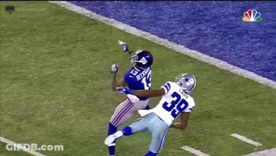 A Football Player With The Number 39 On His Jersey Is Trying To Catch The Ball GIF