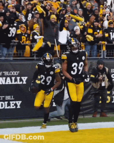 A Football Player With The Number 39 On His Jersey Runs On The Field GIF