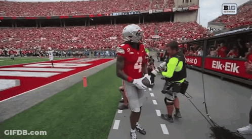 A Football Player With The Number 4 On His Jersey Is Being Interviewed GIF