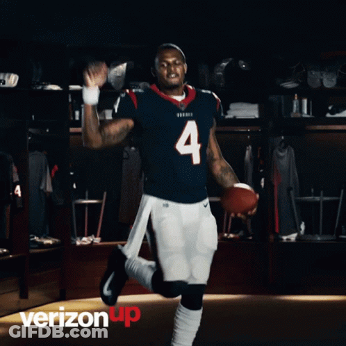 A Football Player With The Number 4 On His Jersey Is Holding A Football GIF