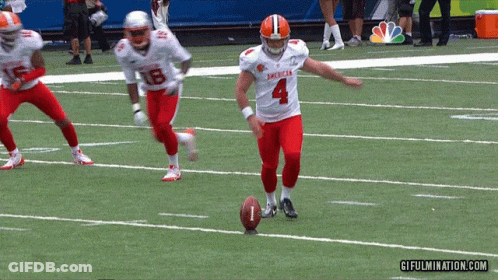 A Football Player With The Number 4 On His Jersey Is Kicking A Ball GIF