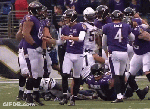A Football Player With The Number 4 On His Jersey Is Surrounded By His Teammates GIF
