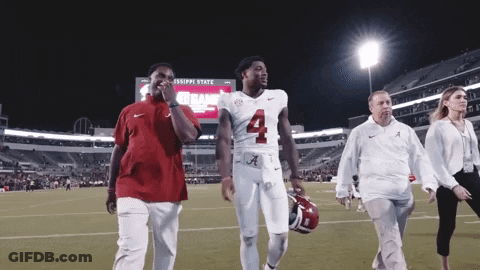 A Football Player With The Number 4 On His Jersey Is Walking On The Field GIF