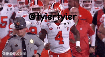 A Football Player With The Number 4 On His Jersey Runs Past A Police Officer GIF
