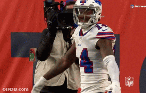 A Football Player With The Number 4 On His Jersey Stands In Front Of A Camera GIF
