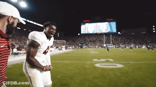 A Football Player With The Number 4 On His Jersey Stands On A Field GIF