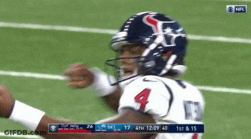 A Football Player With The Number 4 On His Jersey Stands On The Field GIF